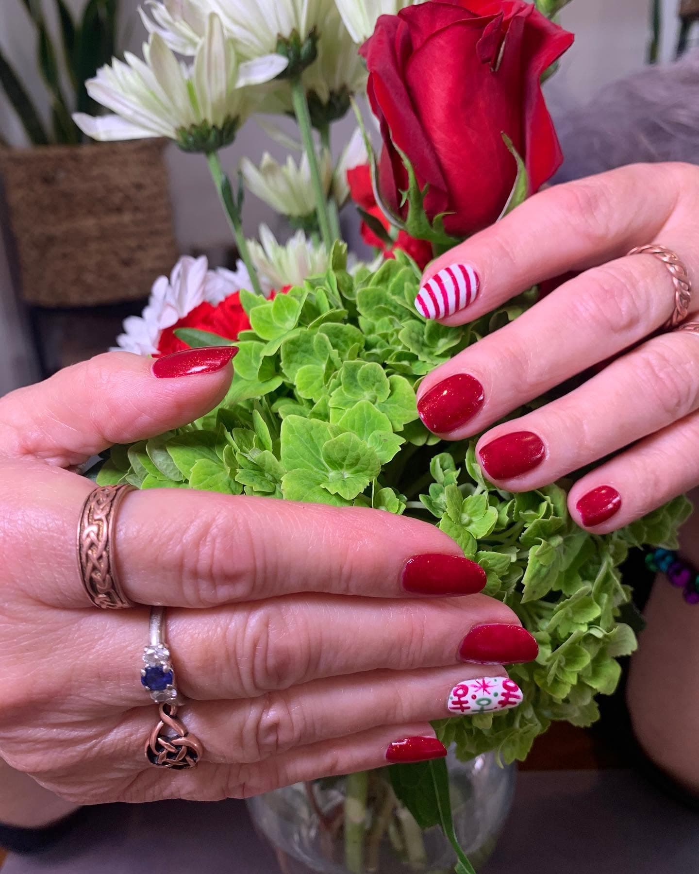 Red and sparkly manicure with candy-cane accent nail